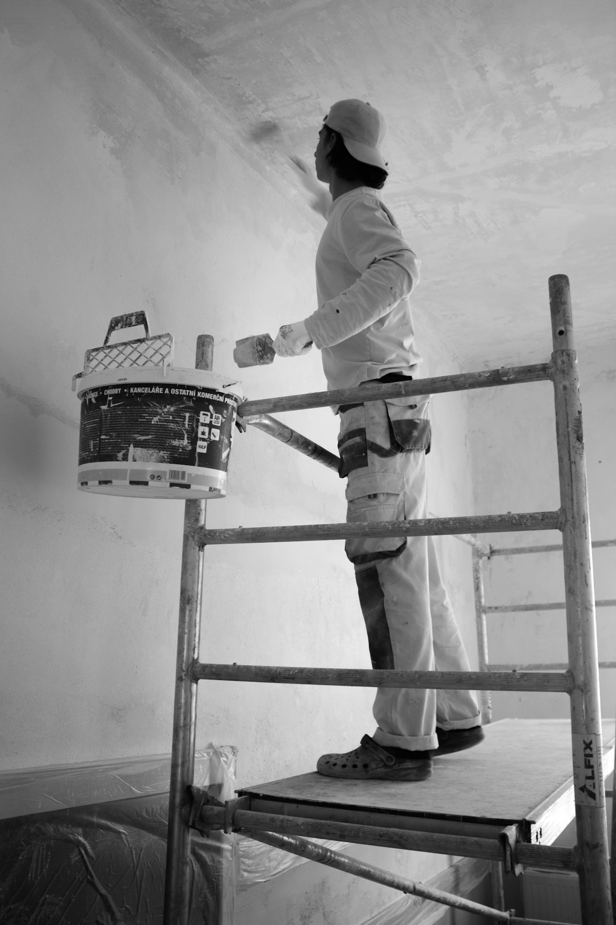 Painter at work on interior wall
